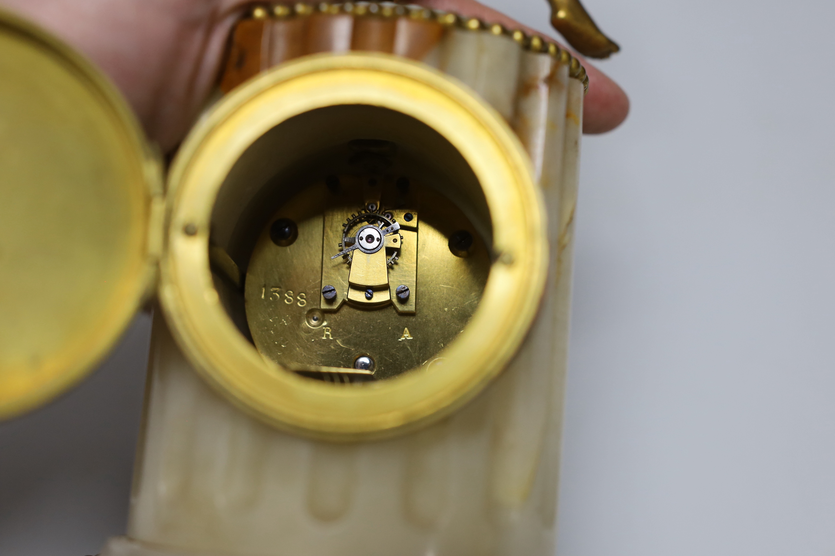 A late 19th century French ormolu mounted onyx mantel clock, 25cm